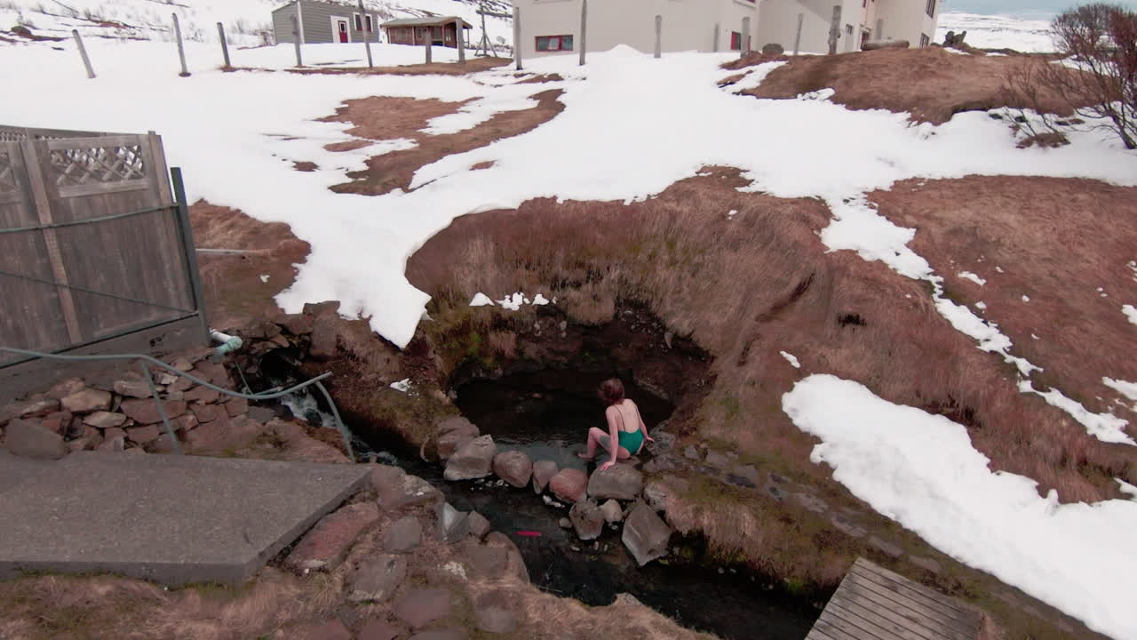 자연 온천으로 걸어가는 소녀