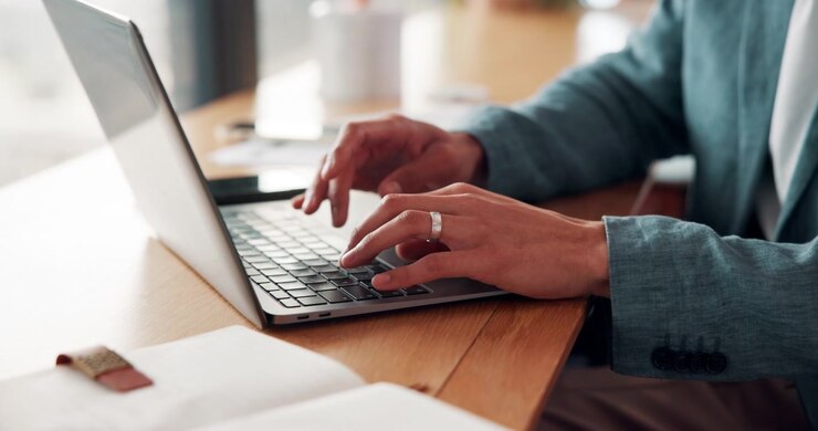 Professional Man Typing on Laptop in Office