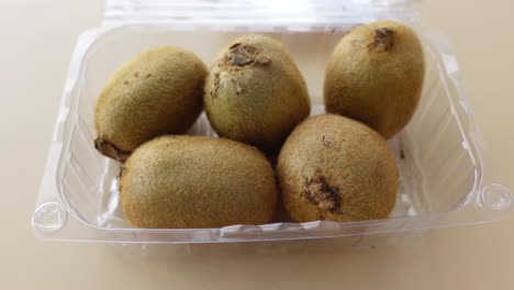 kiwi fruit in plastic container