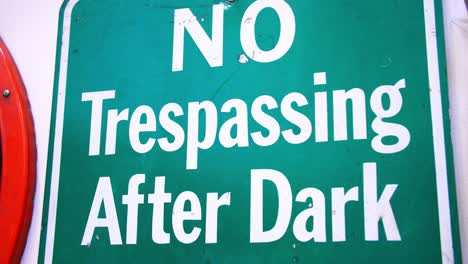 close up footage of a road sign that says "no trespassing after dark