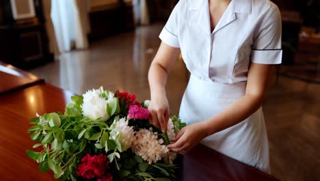 hotel maid arranging flowers