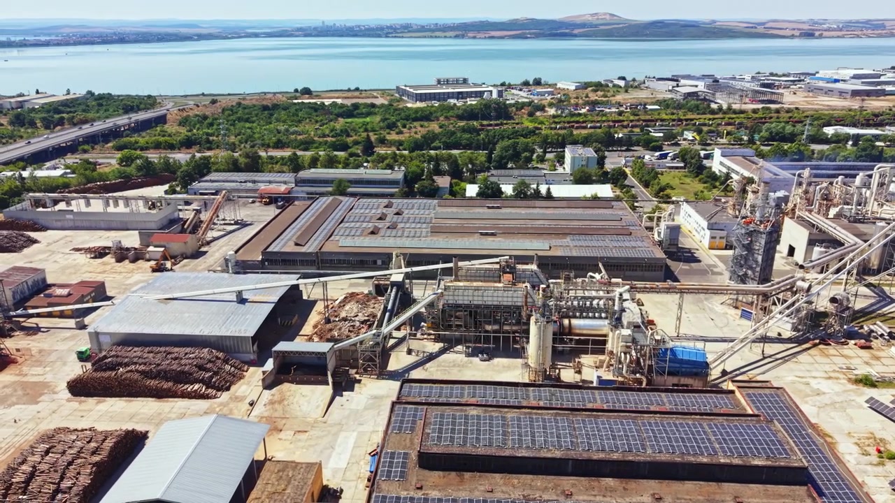 Industry facility located near a river with buildings and machinery during the daytime