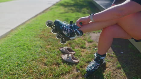 woman preparing to roller skate in a park