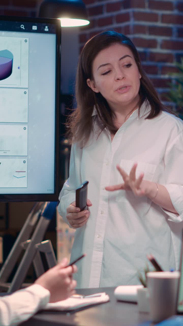Vertical video: Diverse businesswomen in business meeting, employee presenting analytics research