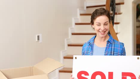 Smiling-young-woman-holding-sign-board-in-her-hands-4K-4k