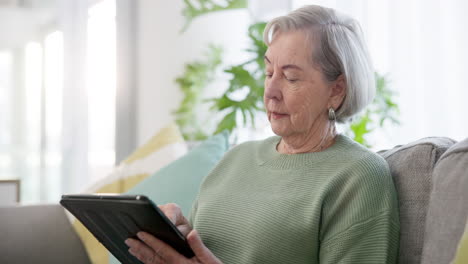 tablet, relax and senior woman on sofa scroll