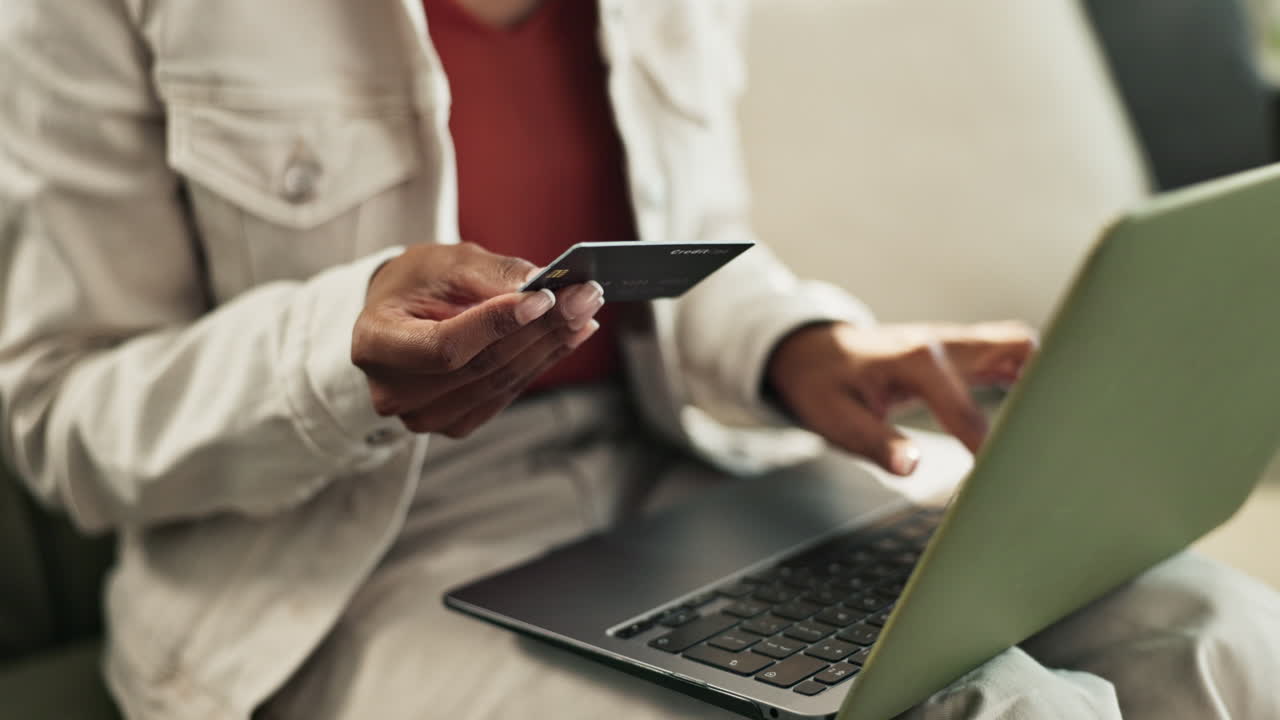 Woman using credit card for online shopping on laptop