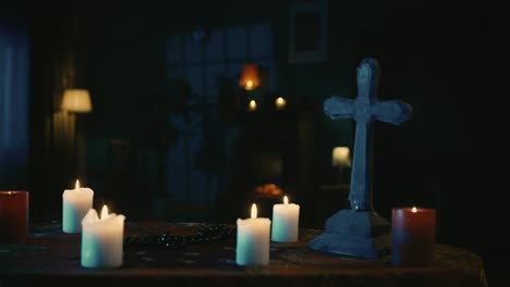 video capturing a table with magical tools on it a priest is sitting at the table with beads in his - video capturing a table with magical tools on it. a priest is sitting at the table with beads in his hands, praying with his eyes closed, when a hand lays on his shoulder. creative content, hallowee