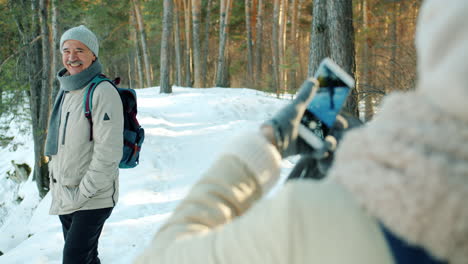 senior man hiked in the snowy forest