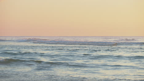 peaceful scene of ocean waves at sunset. static