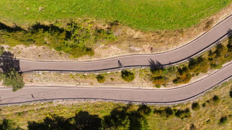 a ciclist riding up to a mountain road