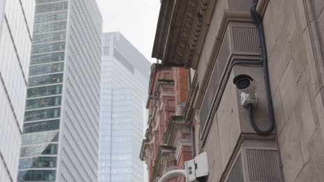 close up of surveillance camera outside modern office buildings in city of london uk 1