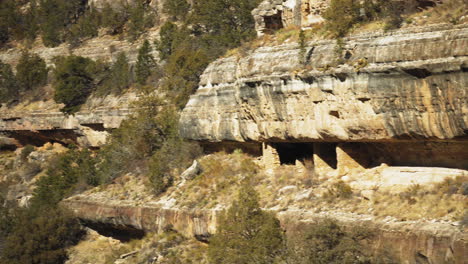 pan right view of cliff side dwellings at walnut canyon