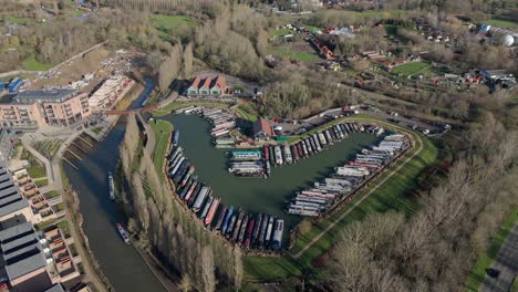 An-aerial-view-of-Campbell-Wharf-Marina-and-the-moored-barges-on-a-sunny-winter-morning-in-Milton-Keynes,-Buckinghamshire,-UK