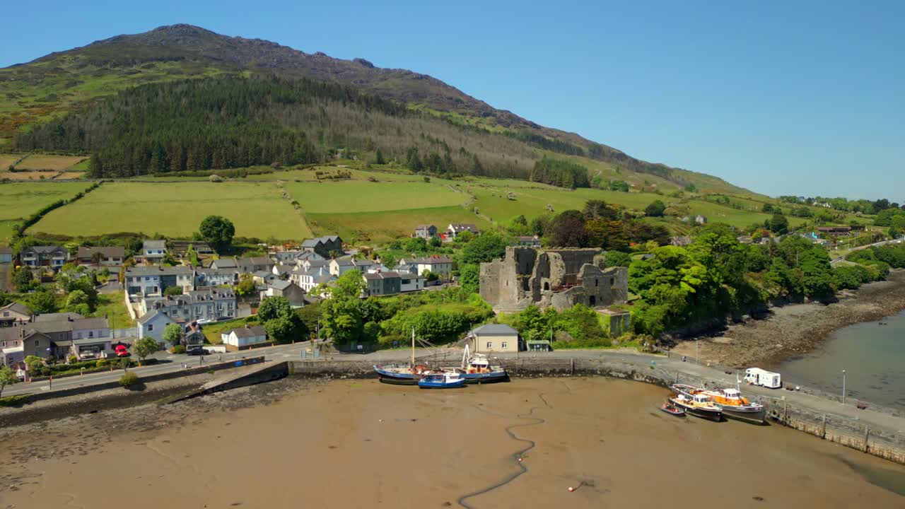 Wide, forward travelling aerial video of Carlingford Castle and Carlingford Lough in Carlingford, County Louth, Ireland on a bright and sunny day. Filmed in 4K, 60FPS and with Rec709 color.