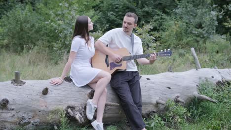 Couple enjoying music in the forest