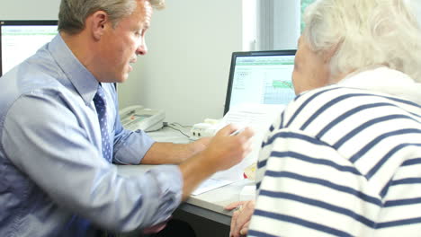 Doctor-Discussing-Test-Results-With-Senior-Female-Patient