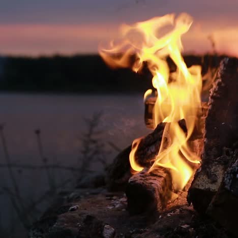 campfire burns brightly at sunset
