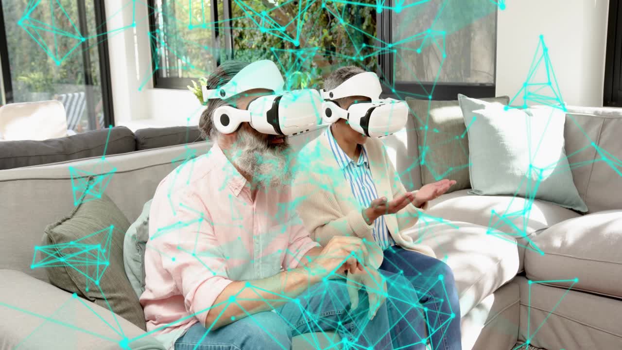 Mature pair wearing VR headsets man raising hand and pinching to navigate turquoise network overlay