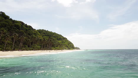 Cinematic-hovering-drone-shot-of-a-sandy-beach-in-Palawan-Philippines,-Aerial