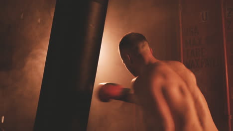 Shirtless-Boxer-Man-Warms-Up-By-Hitting-The-Punching-Bag-1