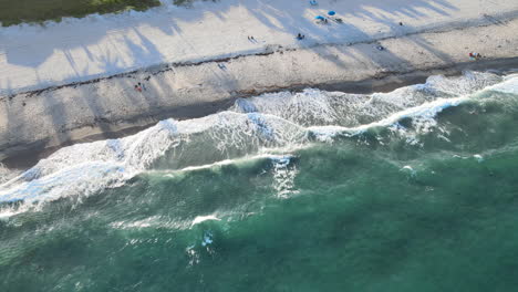 drone looking down on waves crashing