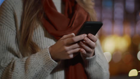 woman hands touching phone screen outdoors. unknown girl using cellphone outside