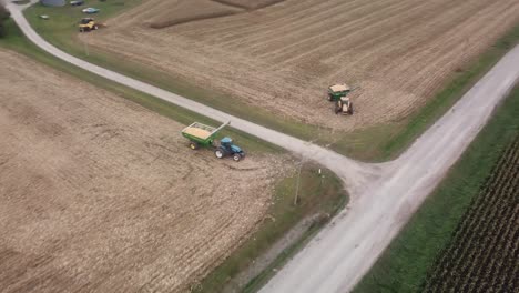 drone flyover of a green cornfield towards a harvested cornfield