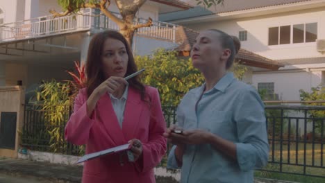 two women inspecting a house