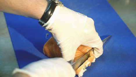 professional sushi chef cutting rolls. redfish. sushi philadelphia