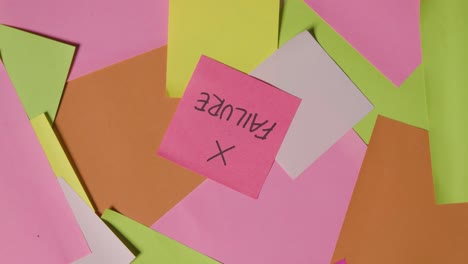 business concept of revolving sticky notes with failure written on top note