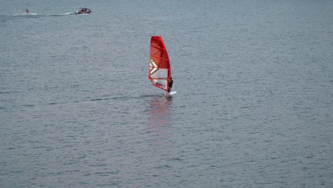 one person windsurfing at han river on sunset, near ttukseom park surfing club, seoul, south korea, static distant view