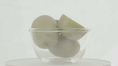 fresh, ripe, green kiwis in rotating bowl, ungraded