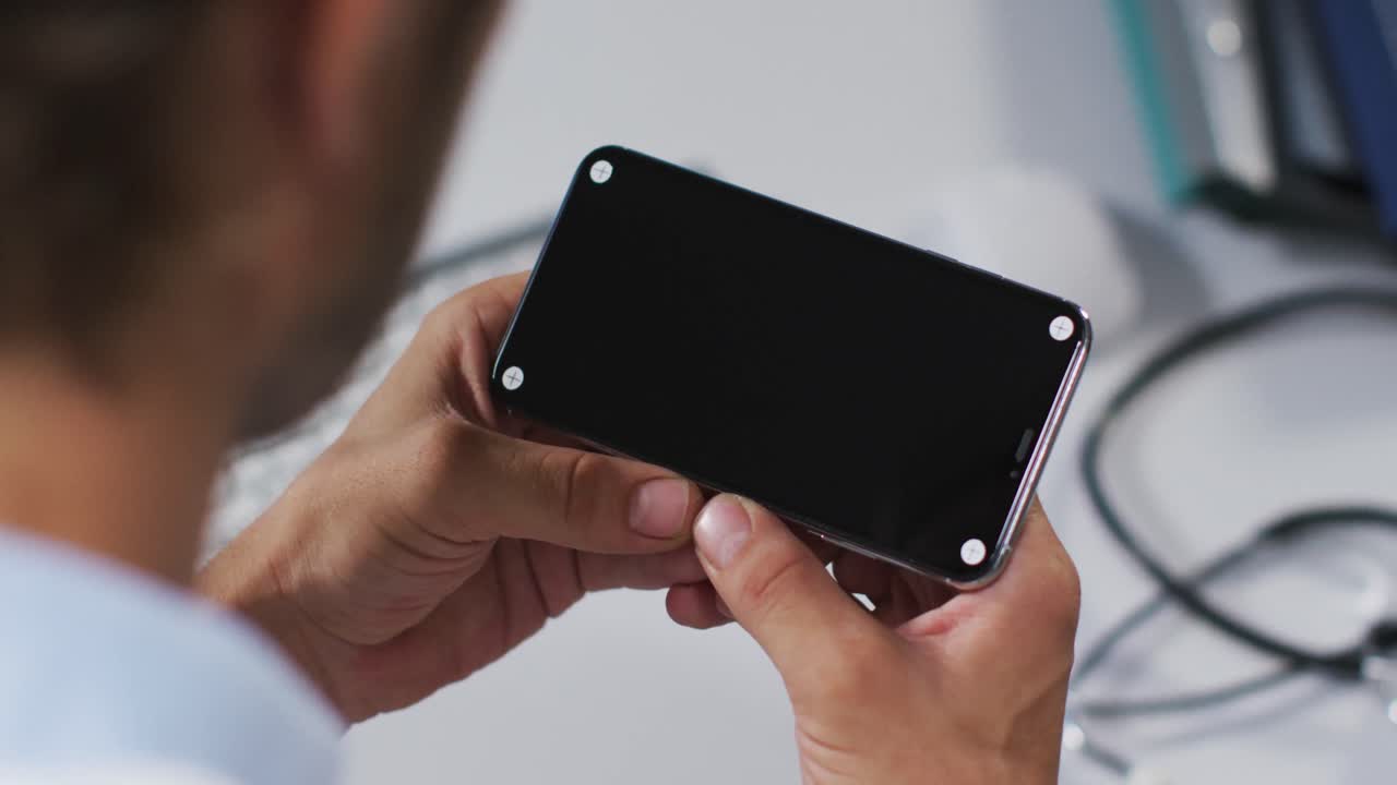 Caucasian male doctor having video call consultation using smartphone