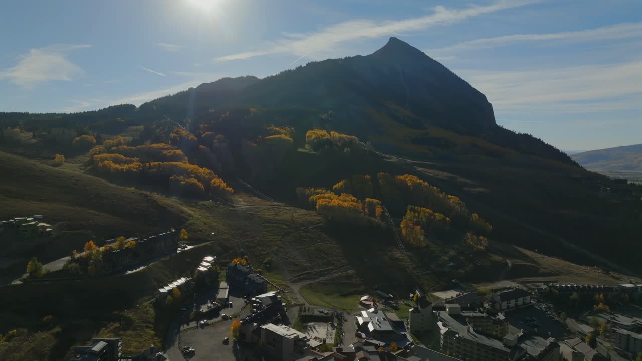Mount Crested Butte ski resort mountain town vibrant thick full Aspen Trees fall autumn auburn peak colors aerial drone Colorado morning Kebler Pass Gunnison National forest sunny bluesky forward pan