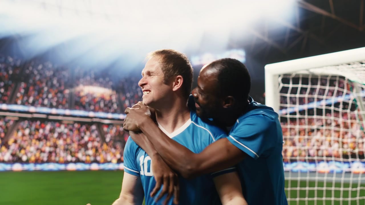 Soccer Players Celebrating a Goal in a Packed Stadium