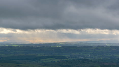 Time-lapse-of-countryside-landscape-with-hills-and-fields-on-a-cloudy-dramatic-day-in-rural-Ireland