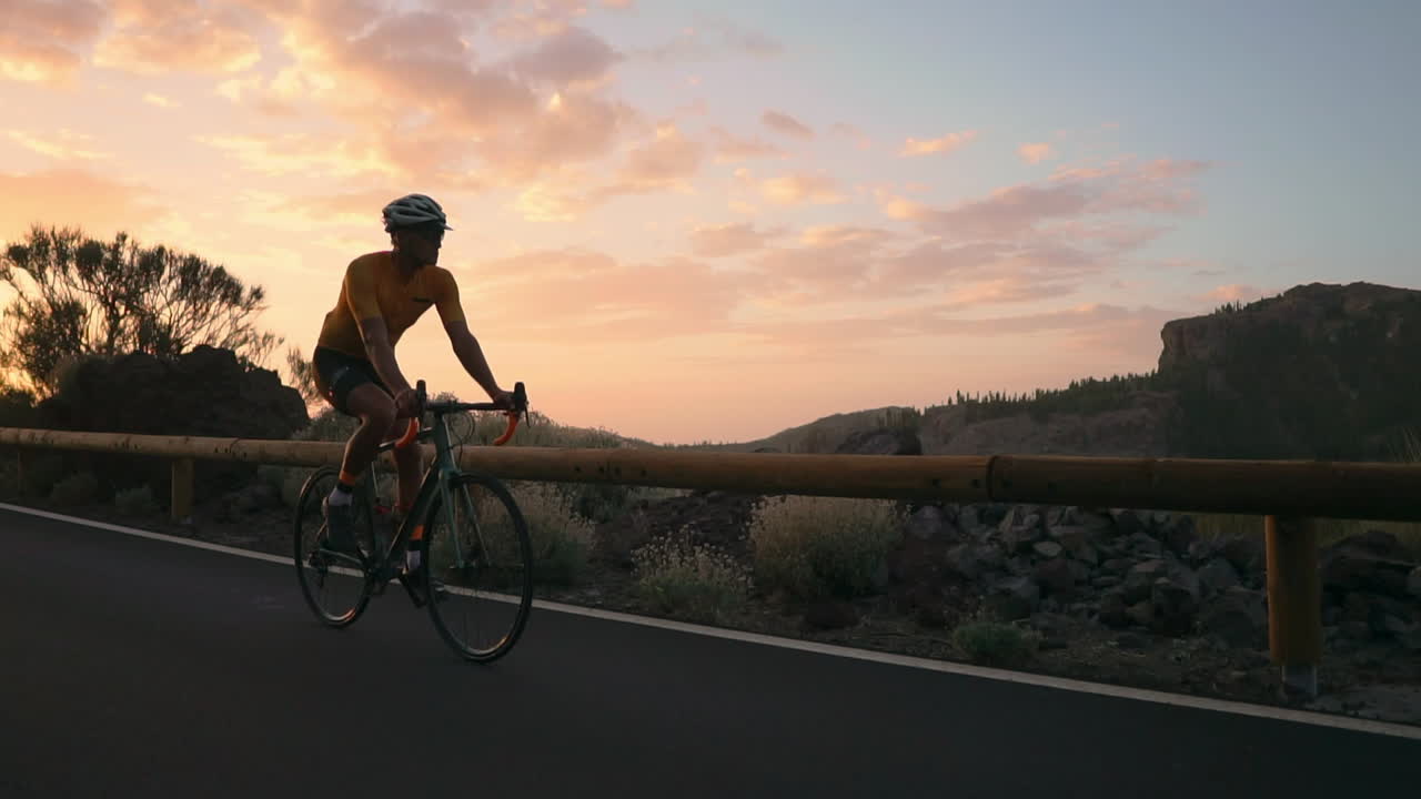 In slow motion, cycling up a mountain serpentine, the athlete beholds the island's picturesque view, reflecting the commitment to a healthy lifestyle