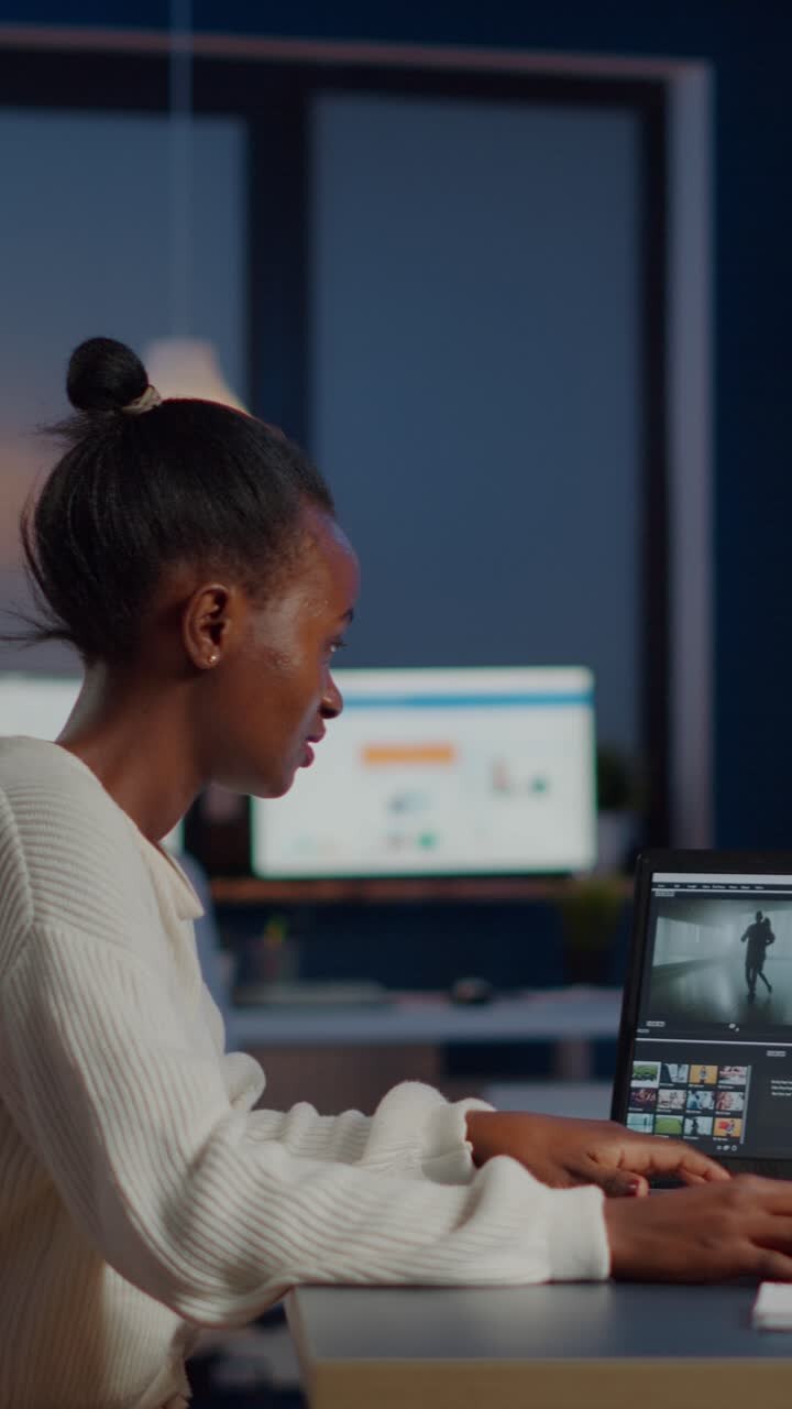 Vertical video Black video editor working overtime at new project editing audio film montage
