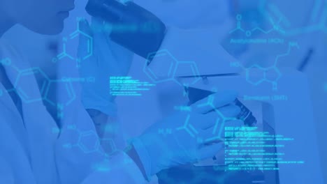 Scientist-using-microscope-in-laboratory-with-data-and-structural-formula-of-chemical-compounds