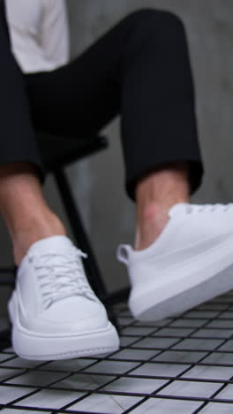 man wearing white sneakers and black pants