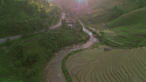 Serene-terraced-rice-fields-and-winding-river-in-the-lush-green-hills-of-Sapa,-Vietnam