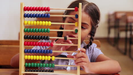 cute pupil learning maths with an abacus