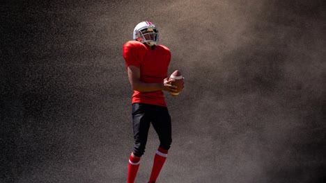 animation of american football player holding ball over smoke, on black background