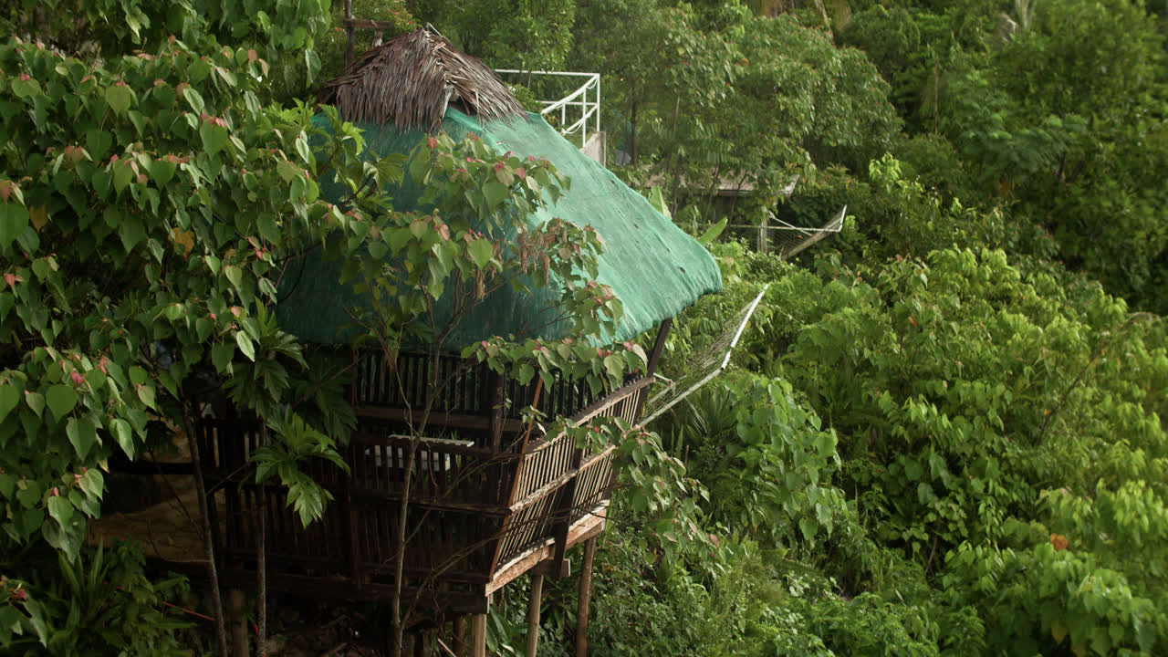 A hut hidden in a lush forest of Canijugan Peak, Dapa, Siargao island in the Philippines.