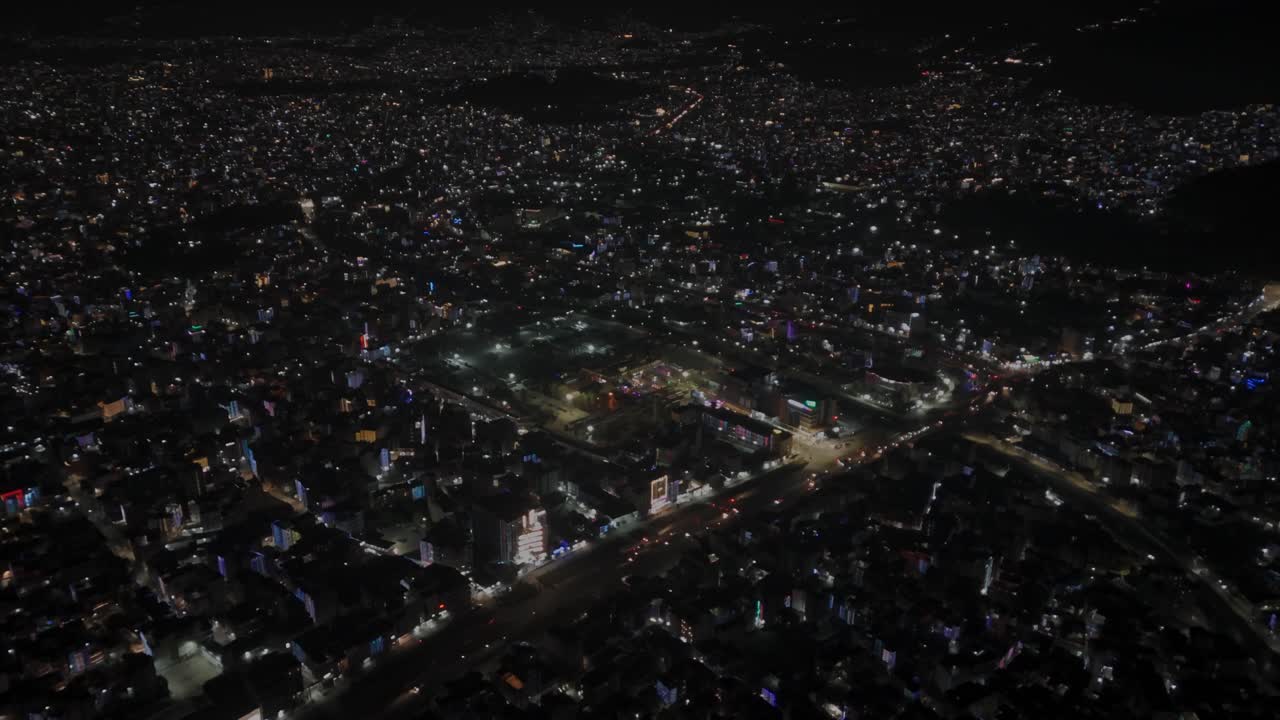 Aerial night footage of Kathmandu city during Diwali (Tihar), featuring the illuminated Dharahara Tower and glowing skyline filled with festive lights, showing Nepal’s vibrant cultural celebration