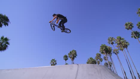 Opinión-De-ángulo-Baja,-De,-Un,-Ciclista-De-Bmx,-Ciclista,-Ejecutar-Un-Salto,-En,-Un,-Skatepark-3