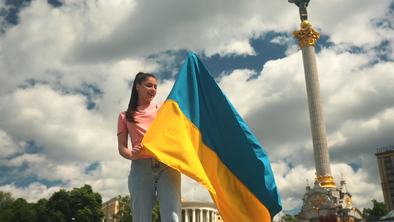 도시 광장에서 우크라이나 국기를 들고 있는 여자