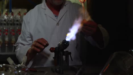 vista frontal de un trabajador masculino maduro creando vidrio en una fábrica de vidrio 4k
