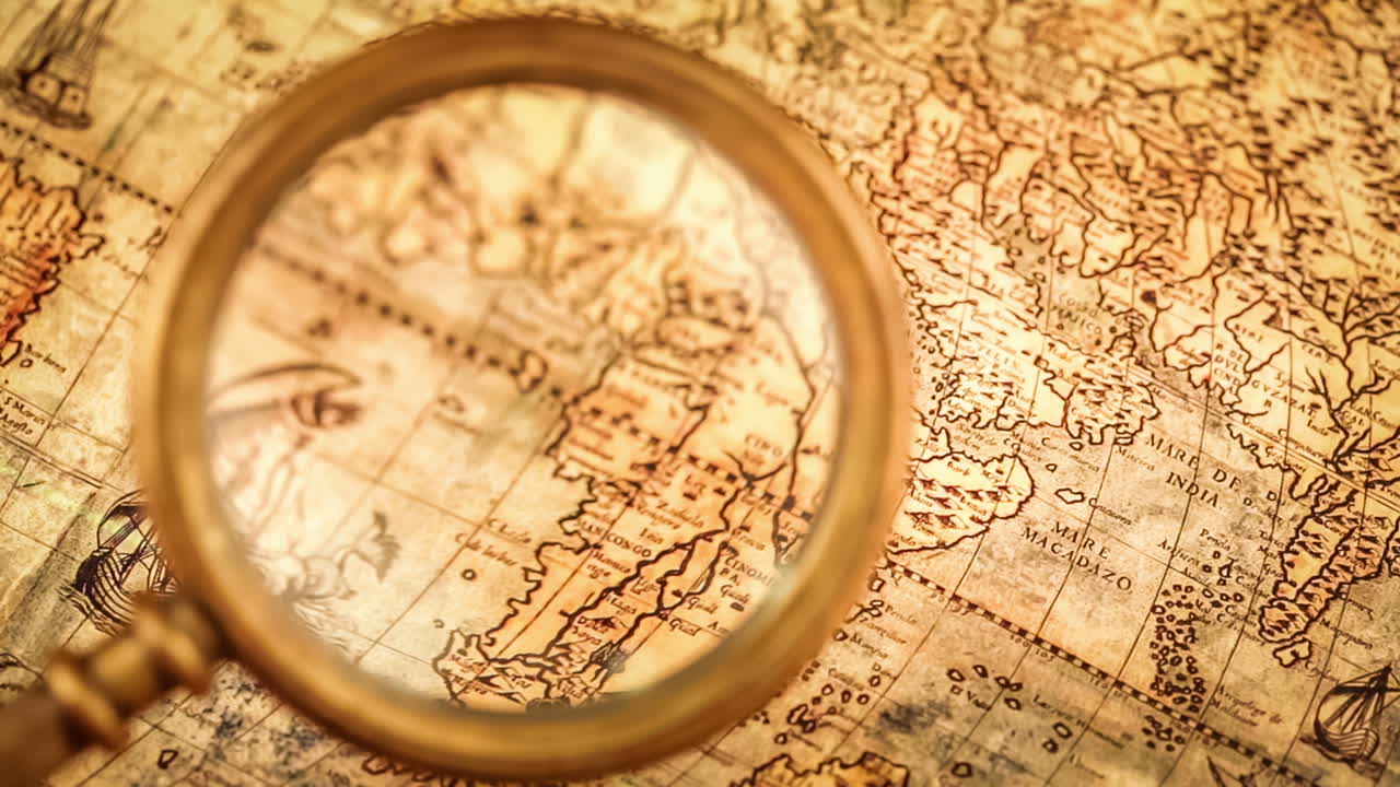 Vintage magnifying glass lies on an ancient world map
